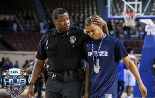 Officer Whitehorn consoling a student after a devastating loss at the State Tournament last year.  